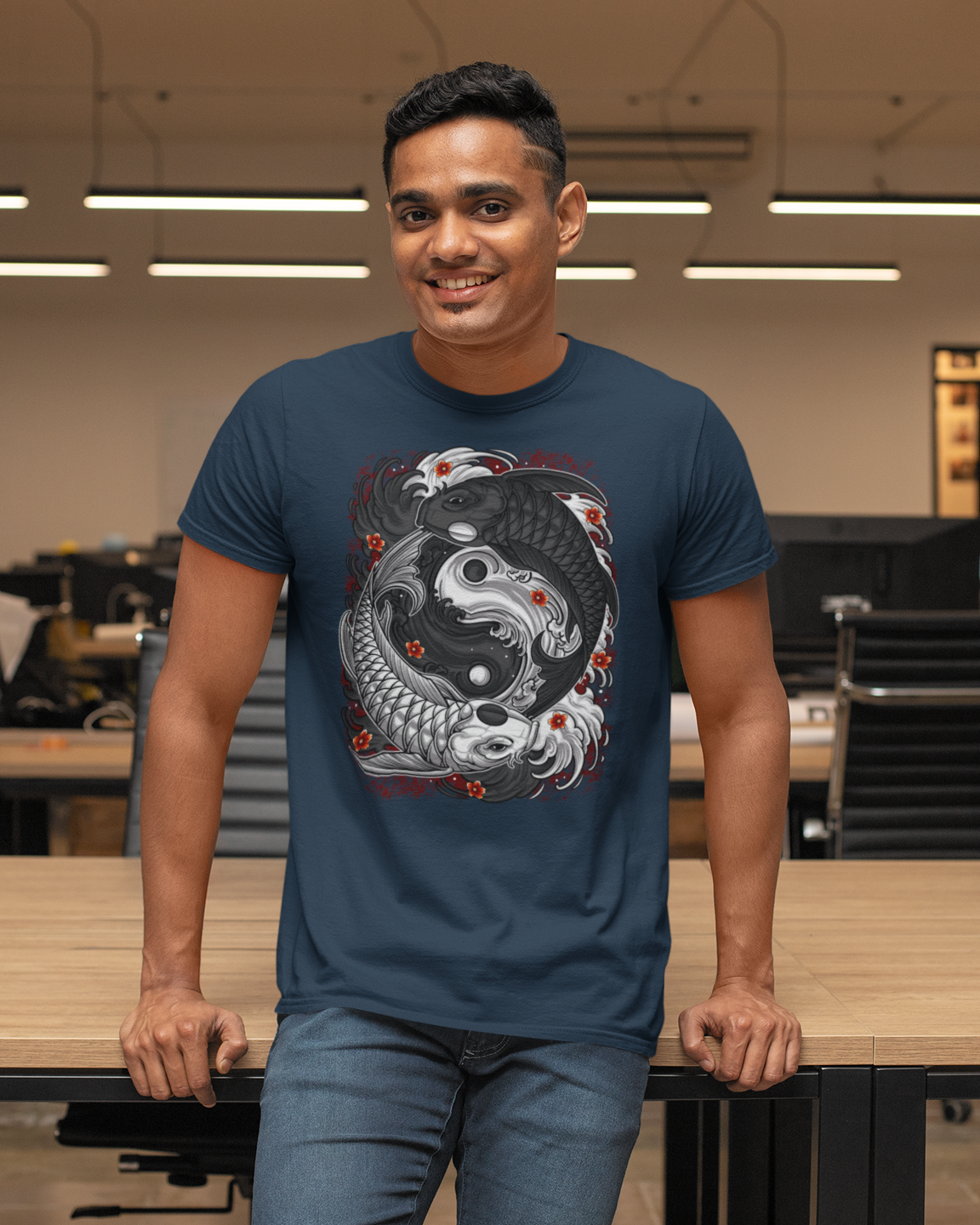 Man wearing a blue t-shirt with a yin yang koi fish design in an office setting