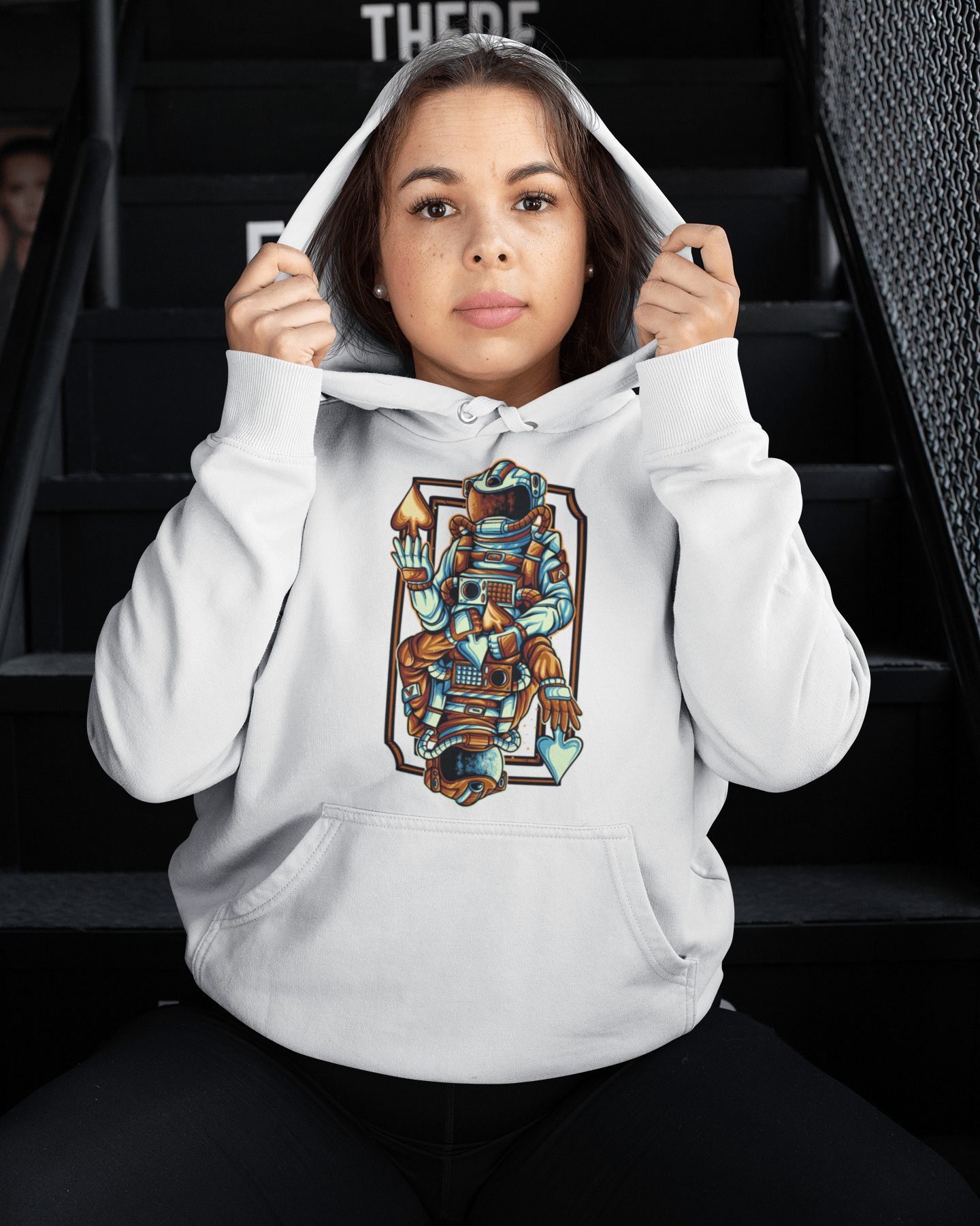 Aswaru-mockup-of-a-woman-wearing-a-hoodie-sitting-on-a-staircase