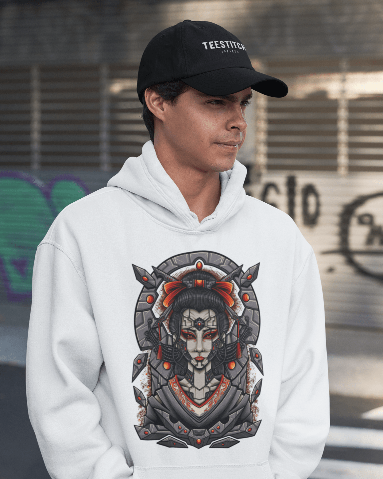 Cyber-Geisha-hoodie-mockup-of-a-young-man-wearing-a-TeeStitch-Apparel-dad-hat-in-an-urban-setting