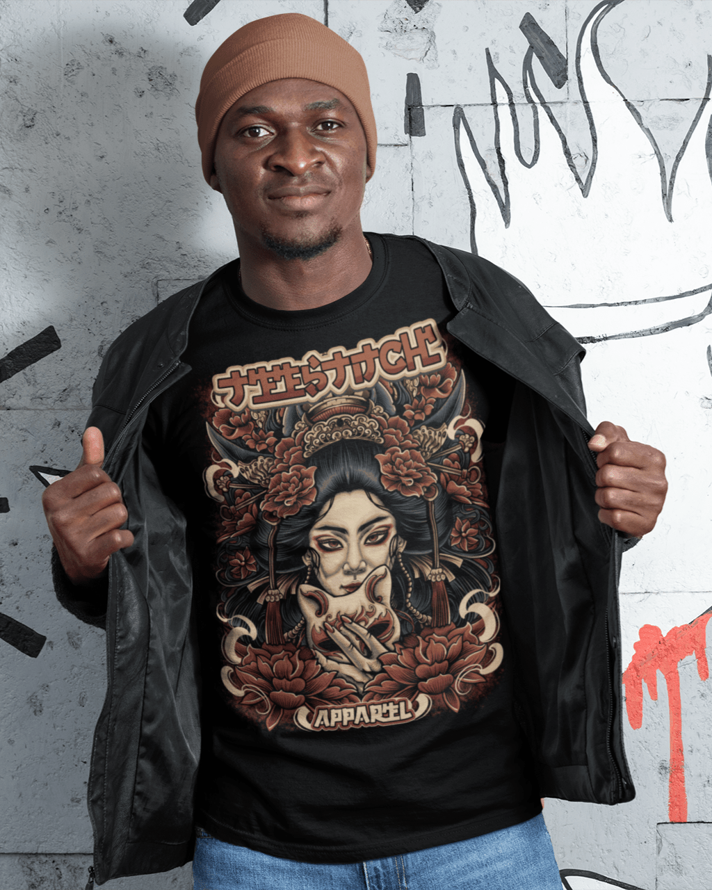 Geisha-Mask-t-shirt-mockup-of-a-man-with-a-beanie-standing-by-wall-drawings