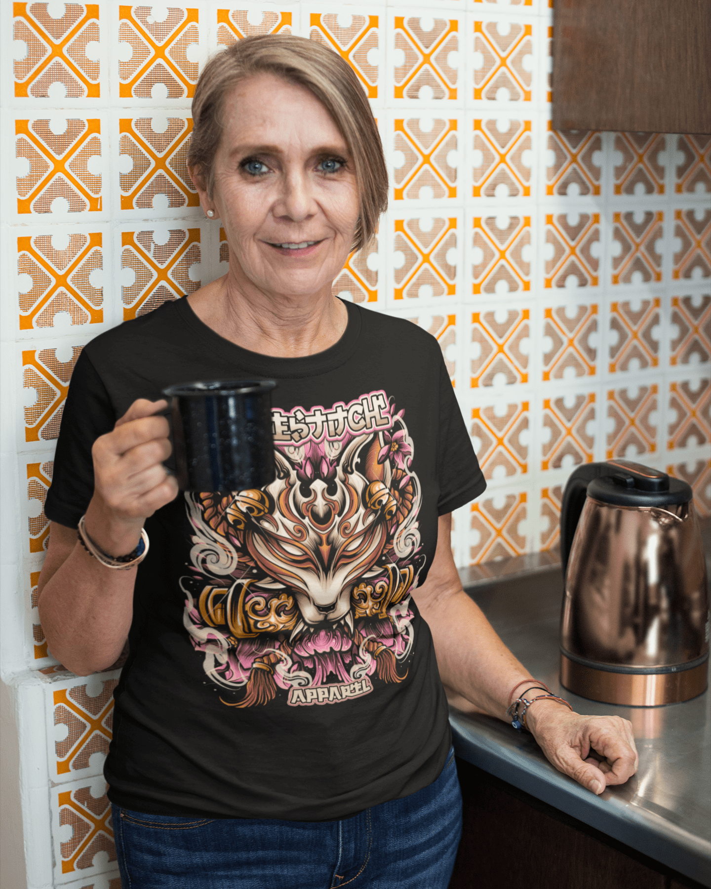 senior-woman-wearing-a-Kitsune-Mask-t-shirt-mockup-while-having-a-morning-coffee