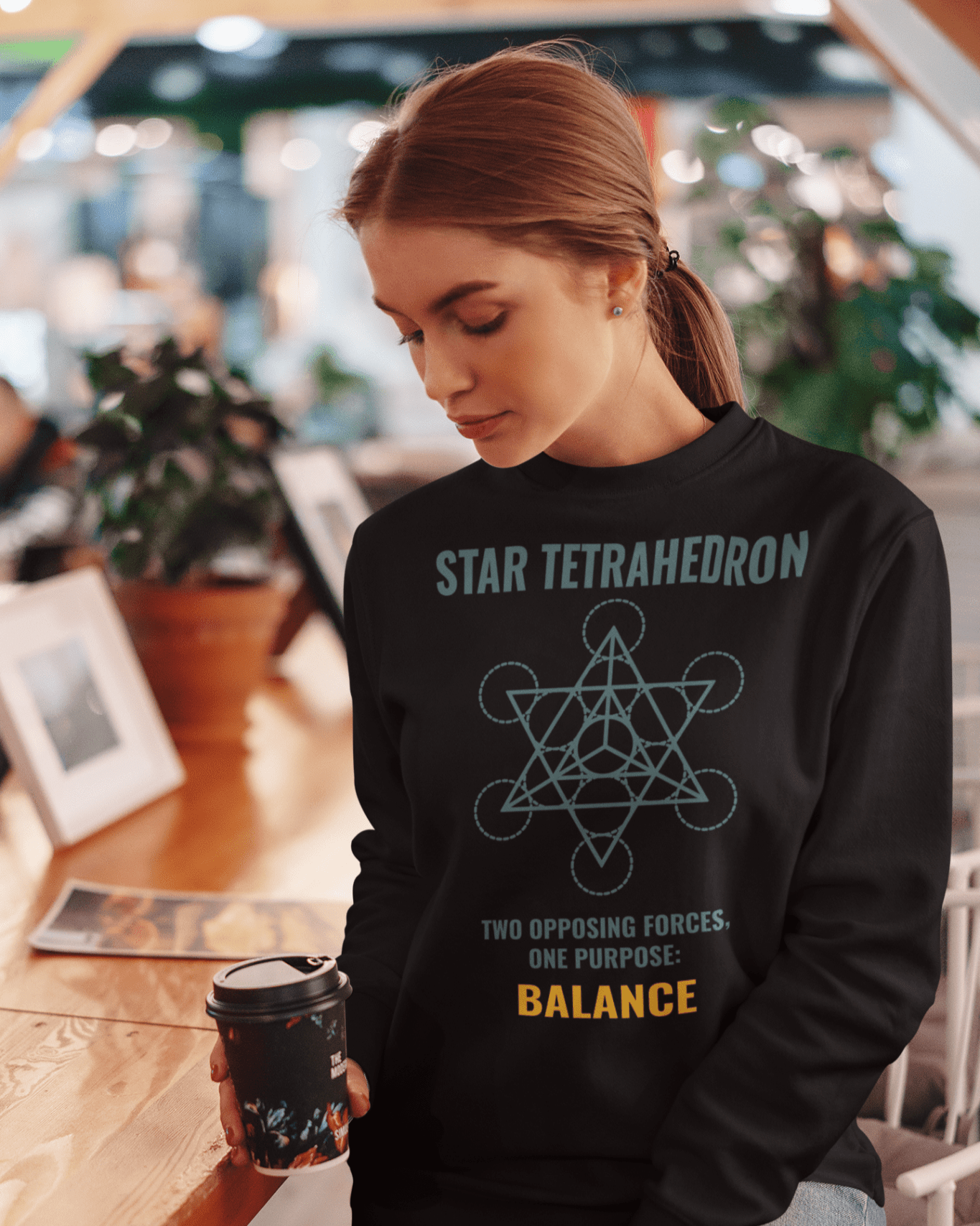 star-tetrahedron-sweatshirt-mockup-of-a-woman-holding-a-coffee-cup