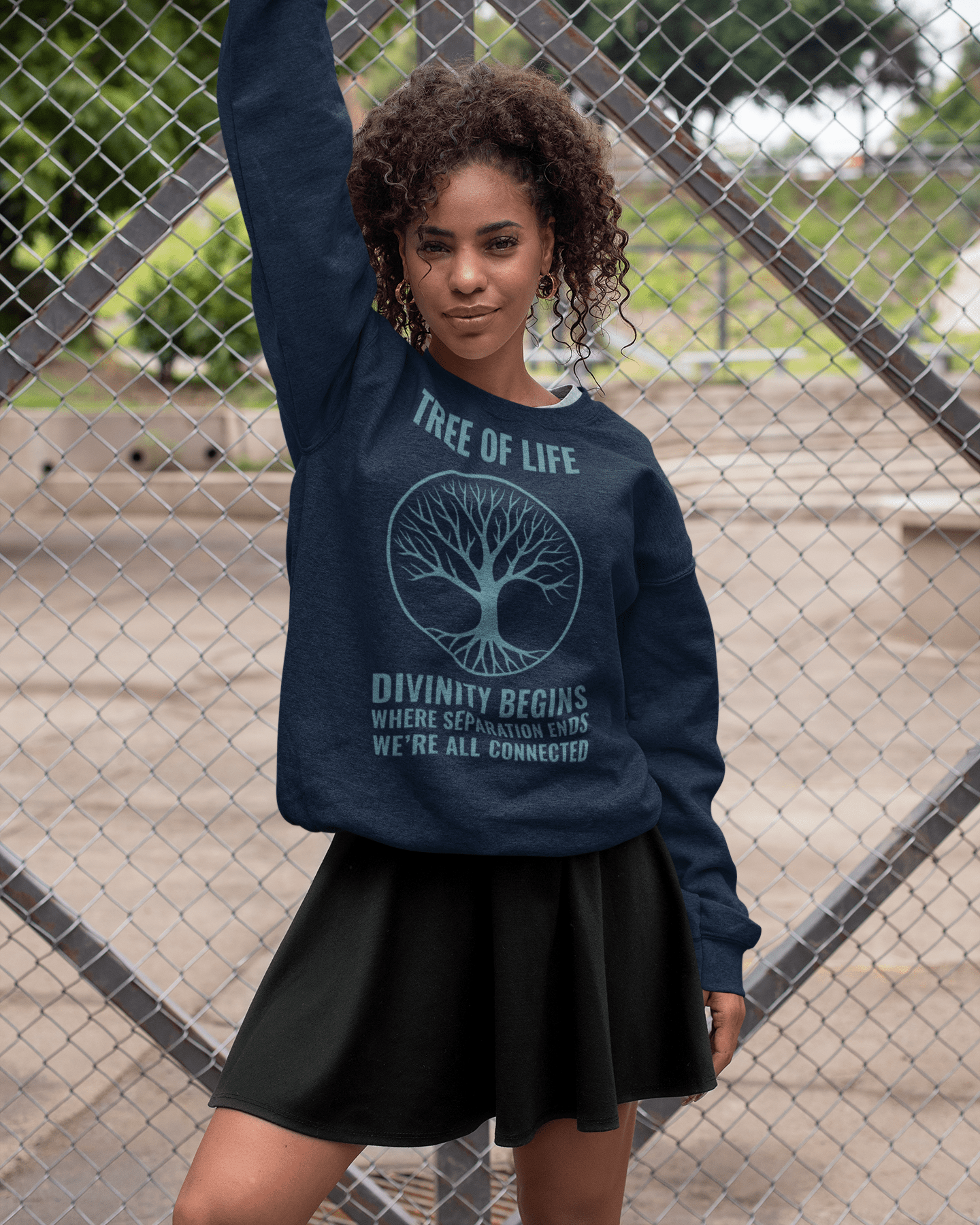 tree-of-life-sweatshirt-mockup-of-a-woman-posing-against-a-wire-fence