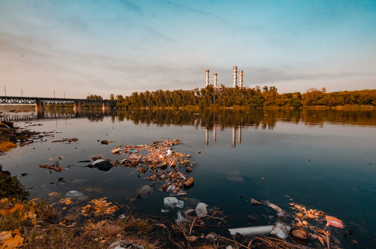 Polluted river with factory in background.