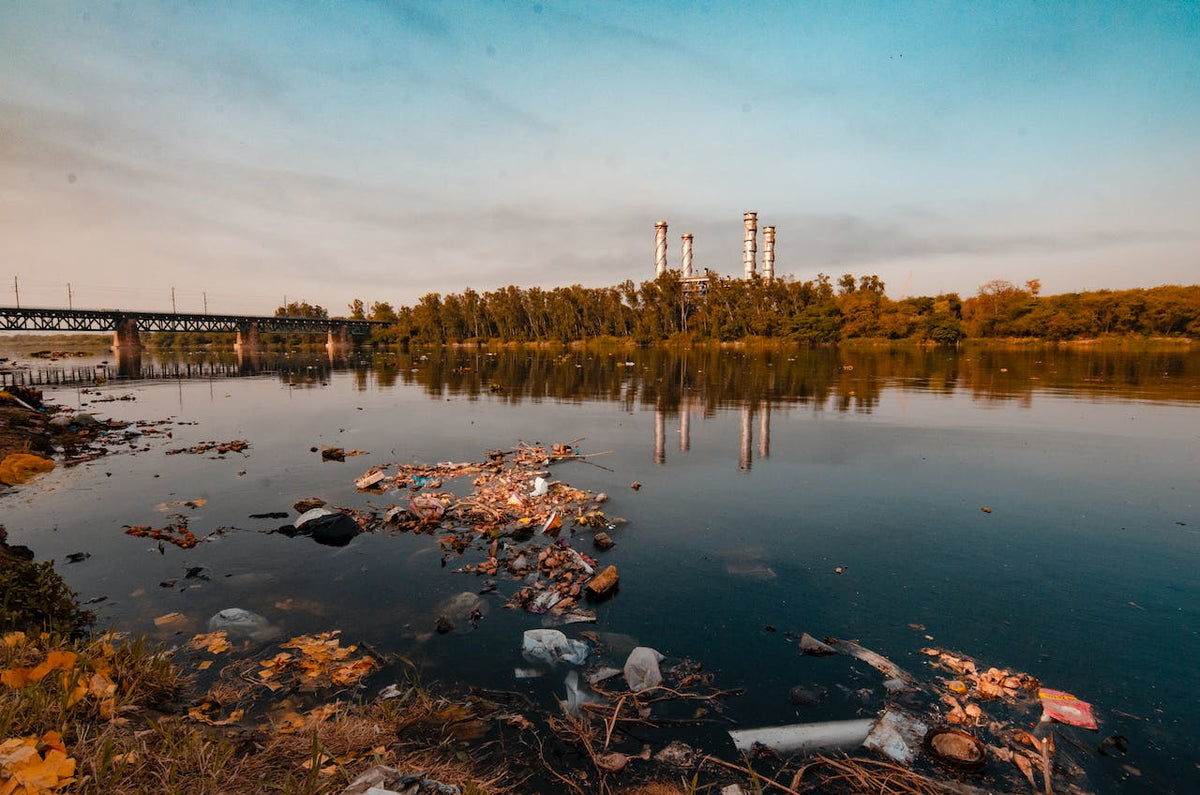 Polluted river with factory in background.