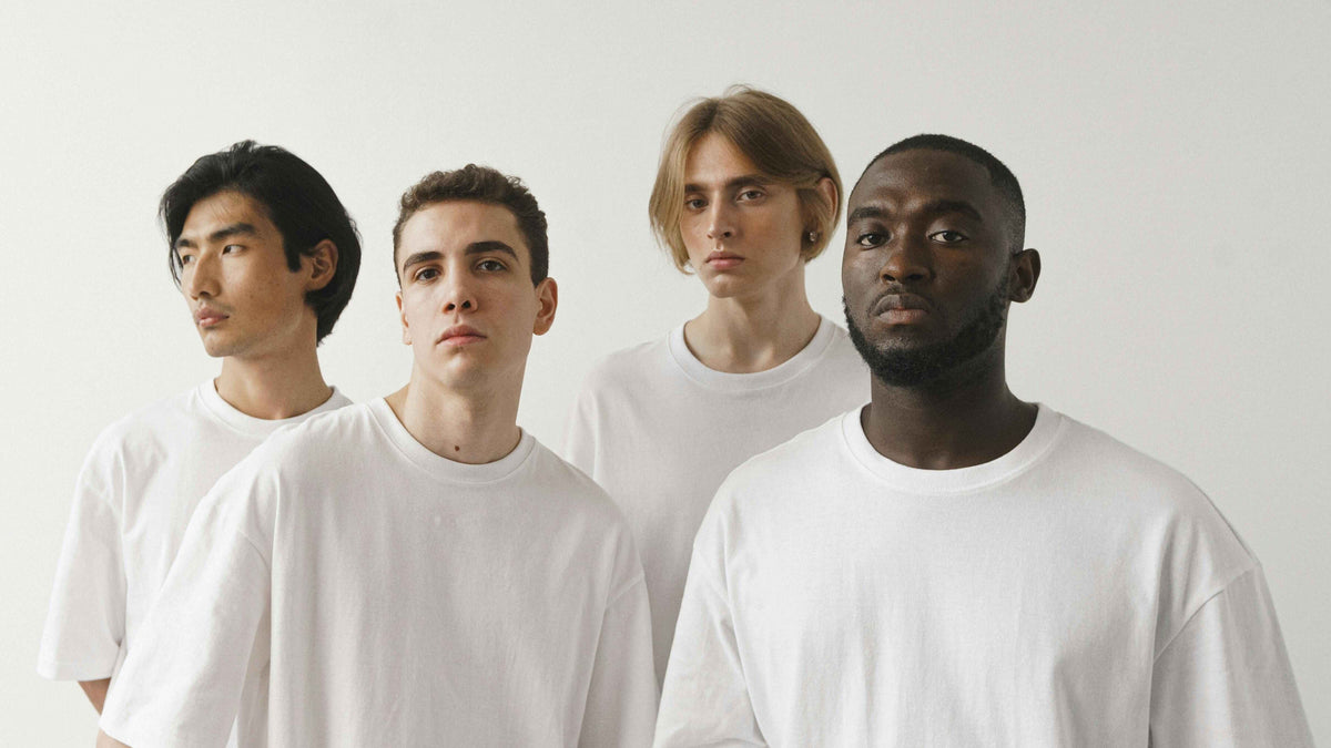 Group of models wearing white t-shirts.