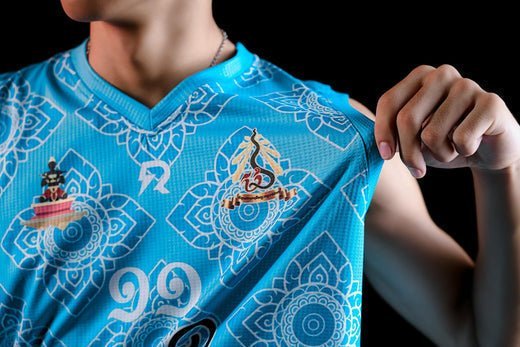 Close-up of person wearing blue sublimated shirt with detailed patterns.