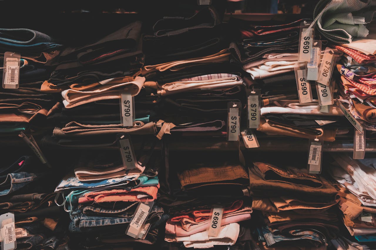 Stacks of folded clothes in a store.