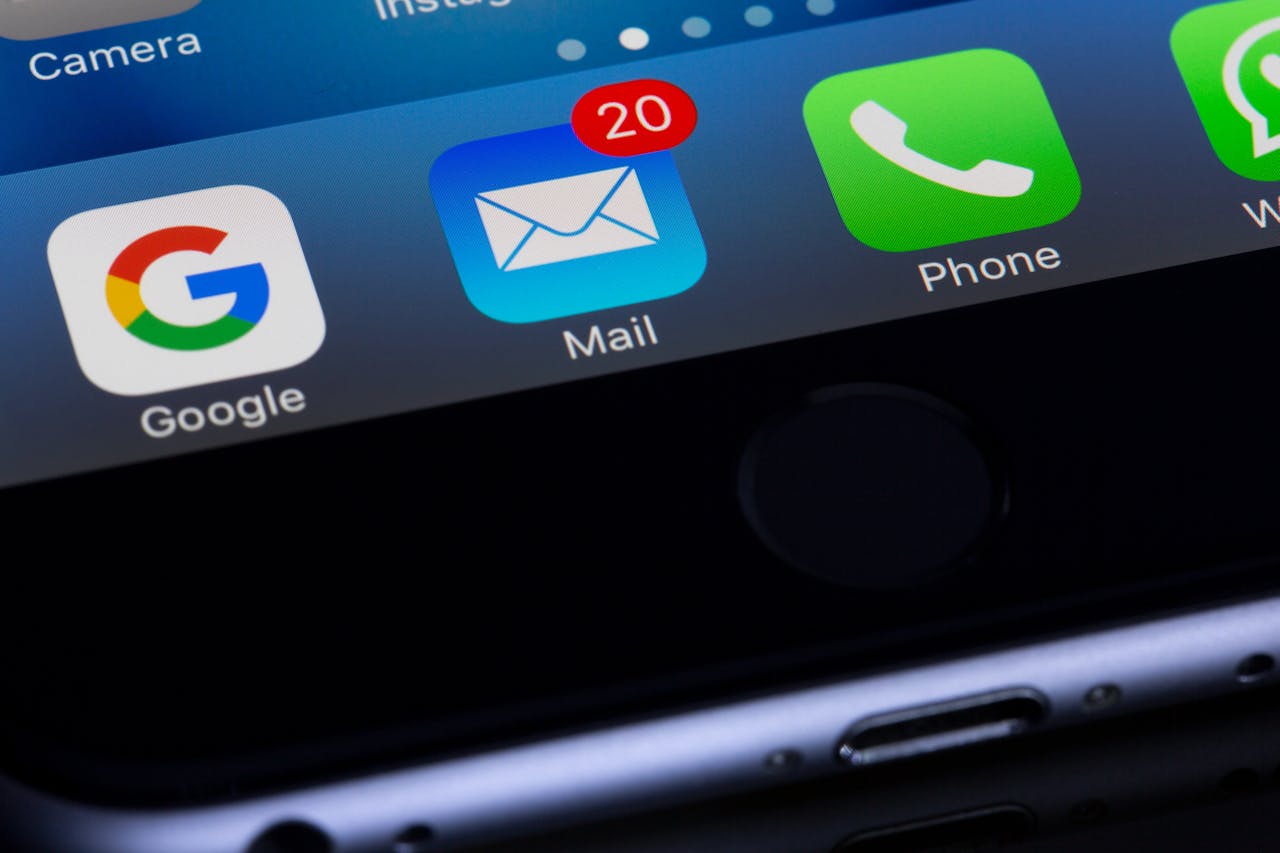 Phone screen with app icons including Google, Mail, and Phone on a dark background