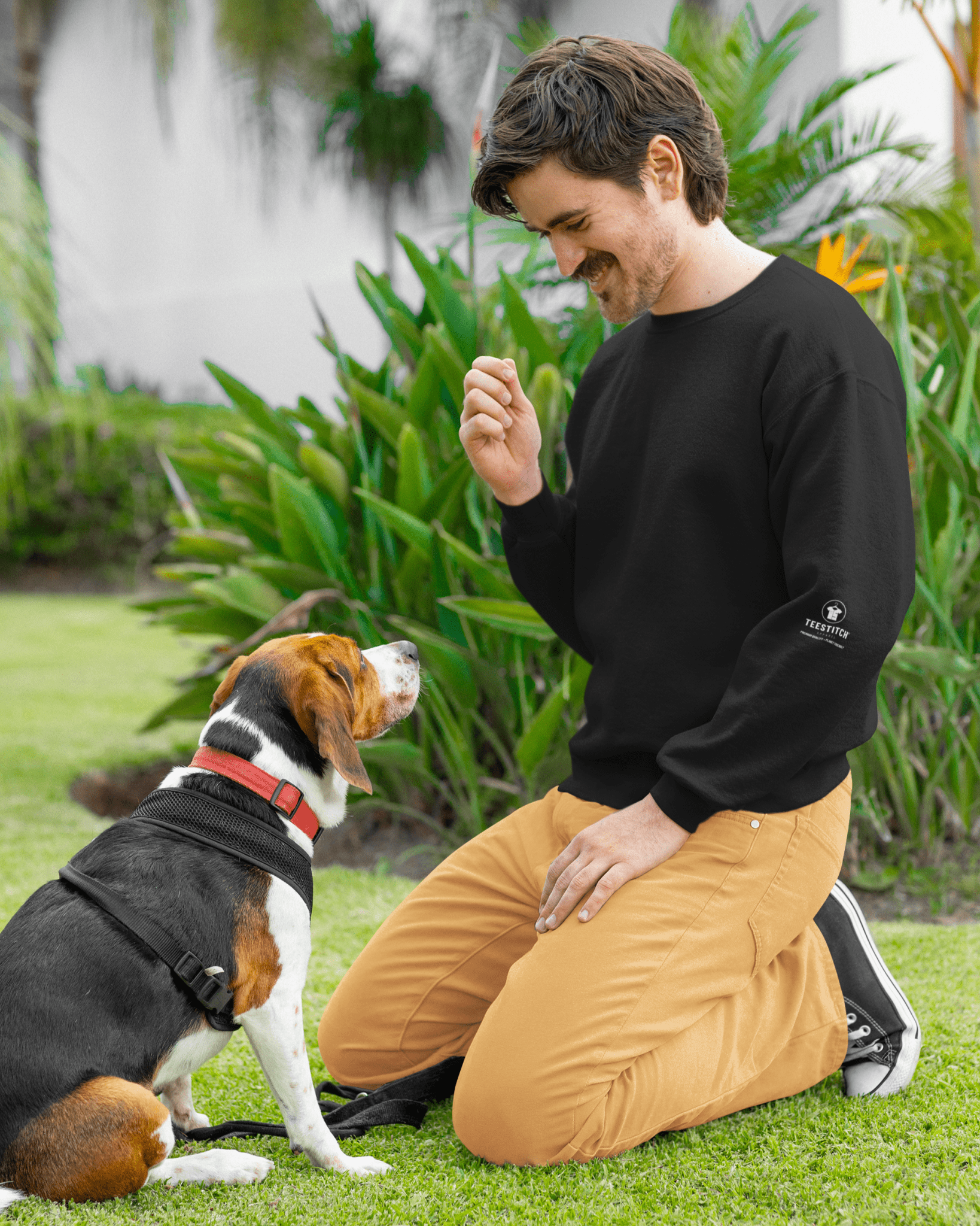 TeeStitch-Apparel-Core-Essentials-sweatshirt-mockup-of-a-happy-bearded-man-training-his-dog