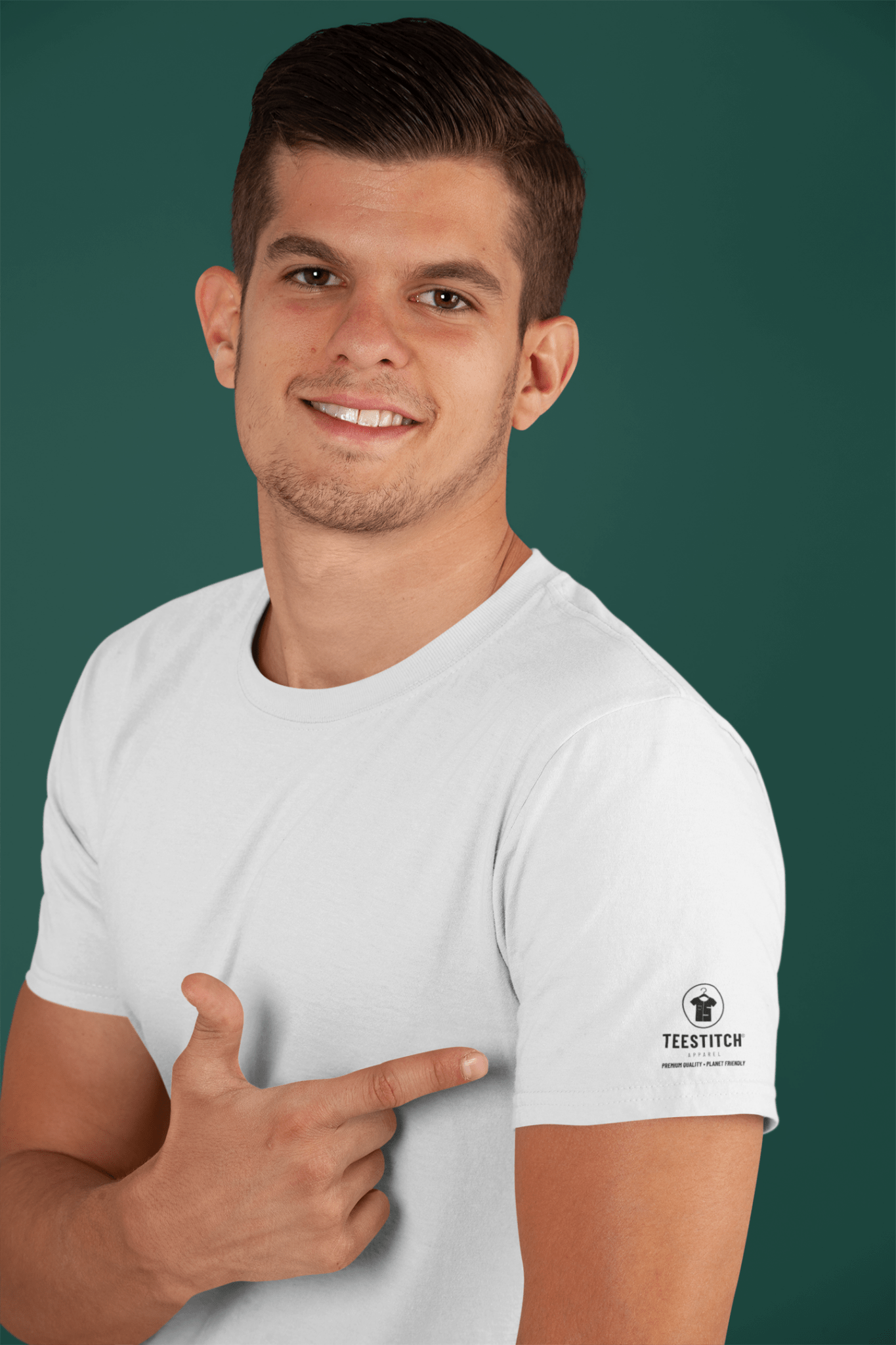 Man wearing a white t-shirt with a brand logo on a green background