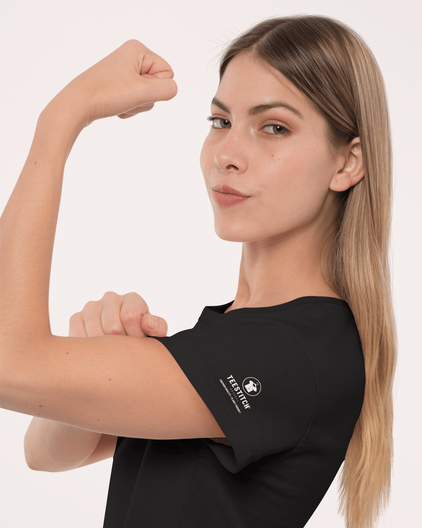 Woman flexing her arm wearing a black t-shirt with a logo on a white background