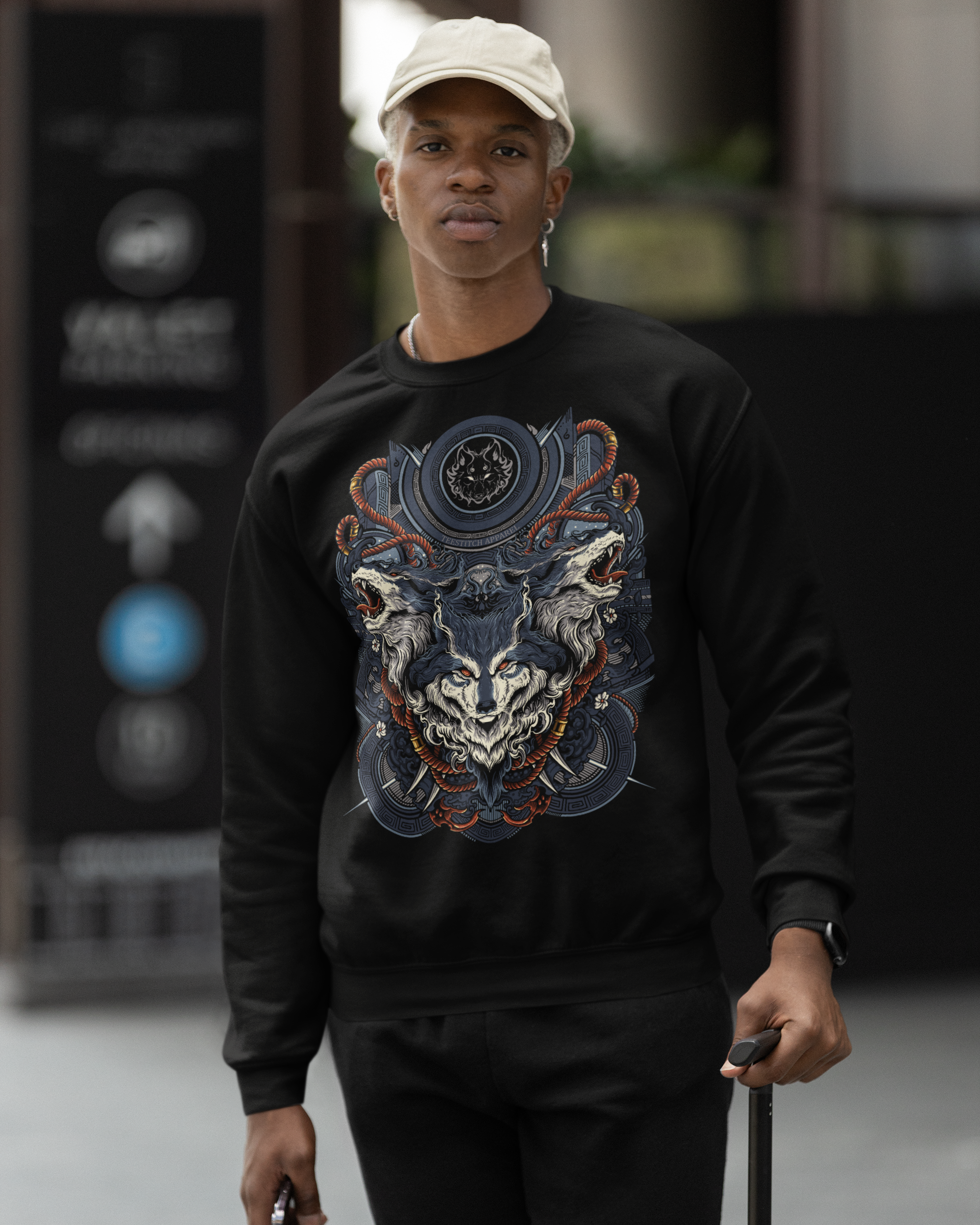 Person wearing a black sweatshirt with a colorful graphic design, standing outdoors. TeeStitch Apparel 