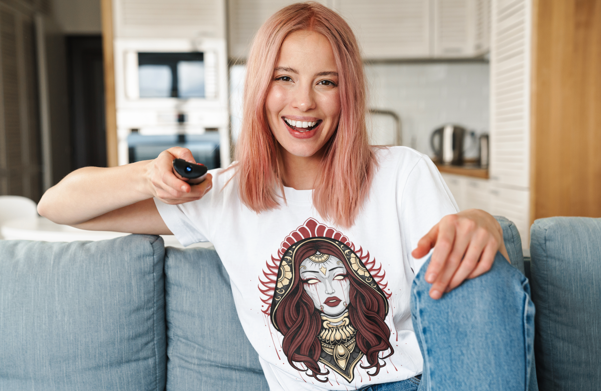 woman sitting on couch wearing a TeeStitch Apparel t-shirt with exclusive design