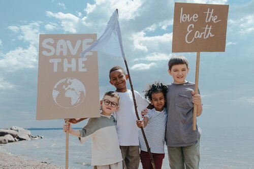 pexels-ron-lach-children-holding-save-the-earth-sign